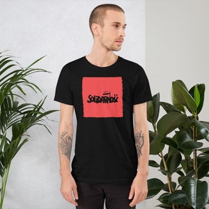 May include: A black t-shirt with a red square graphic that says "Solidarnosc" in black lettering.