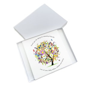 May include: A white gift box with a square card inside. The card features a colorful tree design with flowers and butterflies. Text on the card reads "Thank you for being an amazing Midwife" and "Lots of Love, Baby Willow, Melissa and Garry."