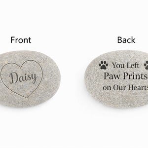 Front and back view of personalised pet memorial stone showing engraved name Daisy in heart and memorial message with paw prints
