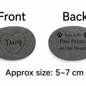 Front and back views of a dark grey pet memorial stone, showing a Daisy heart engraving on the front and You Left Paw Prints on Our Hearts on the back, with approx size 5–7 cm.