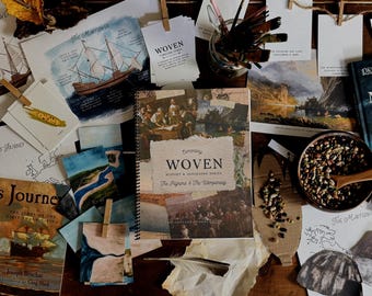May include: An assortment of historical books, illustrations, and art supplies are arranged on a wooden surface. The central focus is a spiral-bound book titled "WOVEN" with the subtitle "The Pilgrims & The Wampanoag." Other books include "The Mayflower" and "Quanto's Journey."