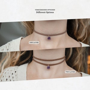 May include: Two suede choker necklaces with a purple gemstone pendant. The top necklace is a single layer and the bottom necklace is a double layer. The text "ONE LAYER" is below the top necklace and the text "TWO LAYER" is below the bottom necklace.