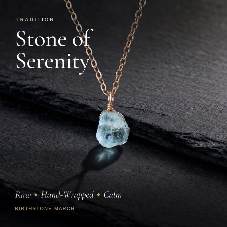 May include: A necklace featuring a raw, light blue stone pendant wrapped in thin metallic wire, suspended from a matching chain. The image includes the text: TRADITION Stone of Serenity Raw Hand-Wrapped Calm BIRTHSTONE MARCH.