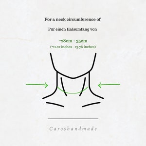 May include: Diagram showing how to measure your neck circumference for a necklace. The diagram shows a person's neck with arrows pointing to the area to measure. The text reads "For a neck circumference of ~28cm - 35cm (~11.02 inches - 13.78 inches)".