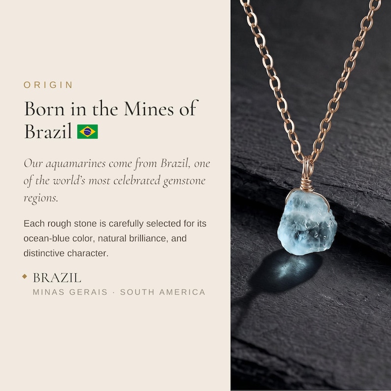 May include: A raw, light blue aquamarine gemstone pendant suspended from a delicate gold-toned metal chain. The stone features an irregular, natural shape and is secured by a wire-wrapped setting. The text reads: ORIGIN Born in the Mines of Brazil.