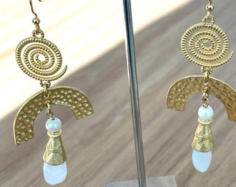 May include: Gold tone earrings with a spiral design, a hammered arch, and a white pearl and stone drop.