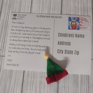 May include: A postcard from Santa's Sleigh Elf with a small elf hat. The postcard has a message to children about a lost hat. The hat is green with a red brim and a yellow pom-pom.