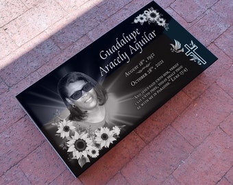 May include: Black granite headstone with a photo of a woman, flowers, and the inscription "Guadalupe Aracely Aguilar August 18, 1952 - October 28, 2021" and a quote from the Bible, "And Jesus said unto him, Verily I say unto thee, Today shalt thou be with me in paradise." Luke 23:43