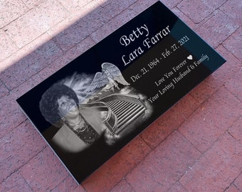 May include: Black granite headstone with a white angel and a stairway to heaven engraved on it. The headstone has the name Betty Lara Farrar and the dates December 21, 1964 to February 27, 2021. The text "Love You Forever" and "Your Loving Husband & Family" are also engraved on the headstone.