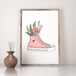 May include: A pink high-top sneaker with a red heart on the side, filled with a bouquet of flowers.