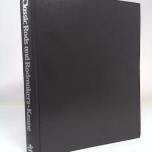 May include: A black hardcover book with the title "Classic Rods and Rodmakers - Keane" printed in silver on the spine.