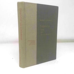 May include: A hardcover book titled "Computation: Finite and Infinite Machines" by Marvin L. Minsky. The book has a two-tone cover, with a light tan spine and a dark gray front and back cover. The title is printed in red.