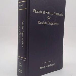 May include: A dark blue hardcover book titled Practical Stress Analysis for Design Engineers by Jean-Claude Flabel. The front cover and spine feature gold lettering. The spine includes the author name, title, First Edition, and Lake City Publishing.