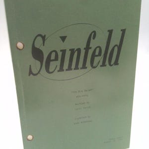 May include: A green script titled "Seinfeld" with the episode title "The Big Salad." The script is held together with two brass fasteners. Additional text includes the writer, director, and date.