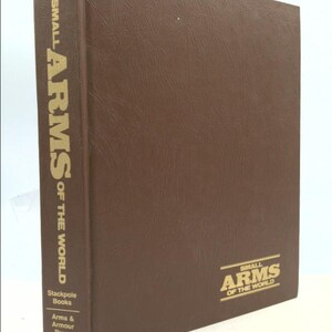 May include: A brown book with the title "Small Arms of the World" on the spine and cover. The book is published by Stackpole Books, Arms & Armour Press.