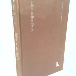 May include: A brown book with the title "Understanding Brecht" by Walter Benjamin. The book is published by New Left Review Editions.