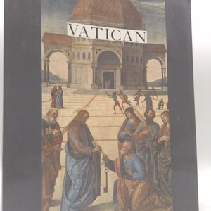May include: A book titled "VATICAN" with a painting of a religious scene. The artwork depicts figures in robes, a building with a dome, and a key being handed over. The book has a black spine and cover.