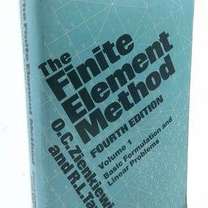 May include: A hardcover textbook titled The Finite Element Method Fourth Edition Volume 1 Basic Formulation and Linear Problems by O.C. Zienkiewicz and R.L. Taylor. The book features a light blue cover with a white geometric grid pattern.