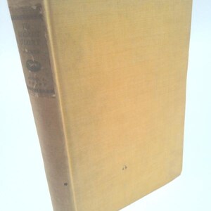 May include: A vintage hardcover book with a light tan cover and spine. The spine features the title "The Secret Story" and other text. The book's cover is plain, with a slightly textured appearance. The book is set against a white background.