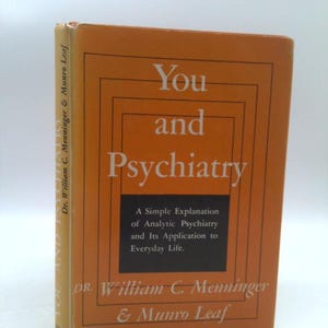 May include: An orange book cover with the title "You and Psychiatry" in white text. The book is by Dr. William C. Menninger & Munro Leaf. The subtitle is "A Simple Explanation of Analytic Psychiatry and Its Application to Everyday Life."