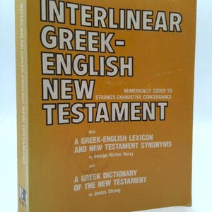 May include: A hardcover book titled "Interlinear Greek-English New Testament" with white text on a gold background. The book includes a Greek-English lexicon and a Greek dictionary of the New Testament.