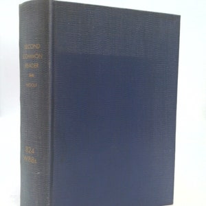 May include: A blue hardcover book with the title "Second Common Reader" and the author "Virginia Woolf" printed on the spine. The book has a Dewey Decimal classification number of 824 W88s.