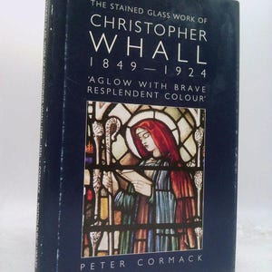 May include: A hardcover book titled "The Stained Glass Work of Christopher Whall 1849-1924" with the subtitle "Aglow with Brave Resplendent Colour." The cover features a stained glass illustration and the author's name, Peter Cormack.