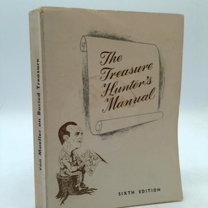 May include: A vintage book titled "The Treasure Hunter's Manual" with a drawing of a man on the cover. The book is a sixth edition and has the author's name, von Mueller, on the spine. The cover is off-white with a scroll design.