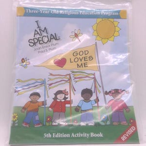 May include: A children's activity book titled "I AM SPECIAL" in a plastic sleeve. The cover features illustrations of children, a sun, and a banner that reads "GOD LOVES ME." The book is labeled as the 5th Edition.