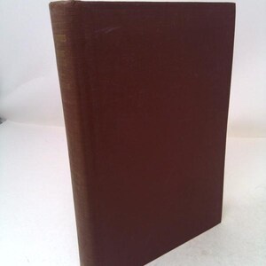 May include: A hardcover book with a dark brown cover. The spine has text in gold lettering. The book is angled slightly, showing the cover and spine. The book appears to be in good condition.