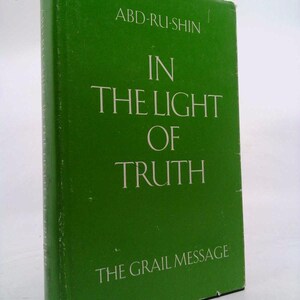 May include: A green book titled "In The Light Of Truth" by Abd-ru-shin. The book is part of The Grail Message series.