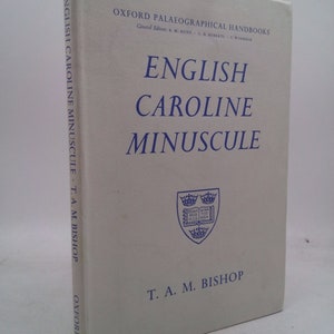 May include: A white book with blue text titled "English Caroline Minuscule" by T. A. M. Bishop. The book is part of the Oxford Palaeographical Handbooks series.