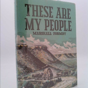 May include: A book cover with a green background and the title "These Are My People" by Marshall Formby. The cover features a painting of a wagon train traveling through a mountainous landscape.
