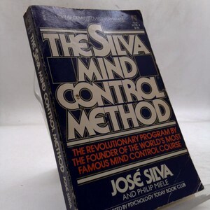 May include: A hardcover book titled "The Silva Mind Control Method" with a navy blue cover and white and orange lettering. The book's cover includes the author's name, José Silva, and the phrase "The Revolutionary Program".