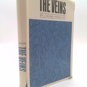 May include: A book titled "The Veins: Normal and Abnormal Function" by J. Edwin Wood, M.D. The cover features a blue and white illustration of veins.