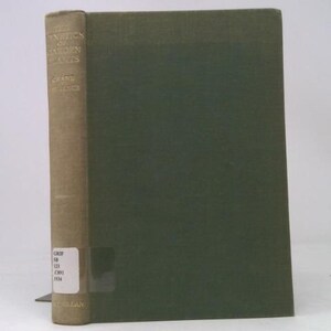 May include: A hardcover book titled "The Genetics of Garden Plants" by C.L.A. Wallace. The spine is tan with gold lettering, and the cover is a muted green. The book is standing upright.