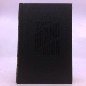 May include: A black hardcover book with embossed lettering and design. The book's spine has gold lettering. The cover features an intricate design with vertical lines and what appears to be a stylized image.