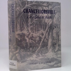 May include: A hardcover book titled "Chancellorsville, Lee's Greatest Battle" by Edward J. Stackpole. The cover features a grayscale illustration of soldiers on horseback and in a forest setting. The book's spine also displays the title.