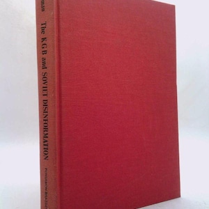 May include: A hardcover book titled "The KGB and Soviet Disinformation" by Bittman. The book has a solid red cover and spine. The title and author's name are printed vertically on the spine in white text.