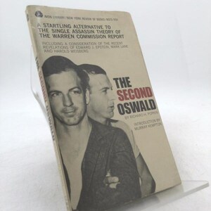 May include: A vintage paperback book titled "The Second Oswald" by Richard H. Popkin. The cover features a black and white image of two men. The book's title and author are prominently displayed.