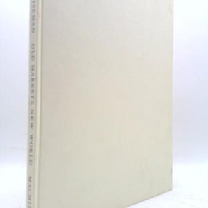 May include: A hardcover book titled "Old Marketta New World" by Hal/Wiseman, published by Macmillan. The book has a light beige cover and spine with the title and author's name printed vertically.