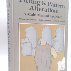 May include: A white ceramic mug with a black handle and the text "But First, Coffee" in a handwritten style. The mug is on a white surface. The mug is 4 inches tall.