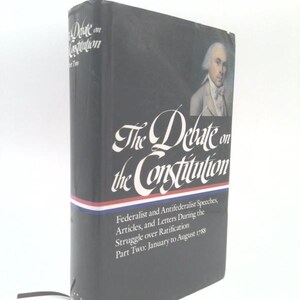 May include: A hardcover book titled "The Debate on the Constitution." The cover is black with white lettering and a portrait of a man in a white wig. The book includes "Federalist and Antifederalist Speeches, Articles, and Letters During the Struggle over Ratification."