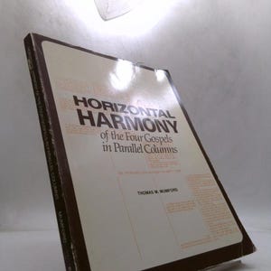 May include: A hardcover book titled "HORIZONTAL HARMONY of the Four Gospels in Parallel Columns" by Thomas M. Mumford. The book has a white cover with black and brown text. The book is slightly angled, showing the spine and the front cover.