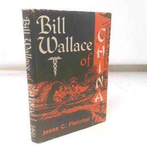 May include: A vintage book titled "Bill Wallace of China" with a black cover and orange accents. The cover features a boat scene and the author's name, Jesse C. Fletcher. The book's spine reads "Bill Wallace of China".