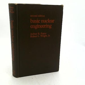 May include: A dark brown hardcover textbook titled Basic Nuclear Engineering, second edition, by Arthur R. Foster and Robert L. Wright, Jr. The front cover and spine feature the title and author names printed in a bold, dark orange font.