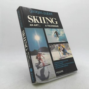 May include: A vintage book titled "Skiing: An Art... A Technique" by Georges Joubert. The cover features images of skiers and a bright sun. The book is in good condition.