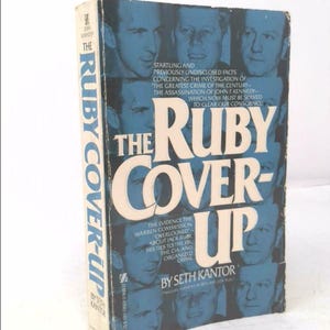 May include: A book cover with a white background and a red, white, and blue title: "The Ruby Cover-Up". The cover features black and white photos of men, including Jack Ruby, and the text "The Evidence the Warren Commission Overlooked - About Jack Ruby, His Ties to the FBI, the CIA, and Organized Crime." The book is by Seth Kantor.
