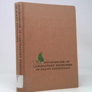 May include: A hardcover book titled "Sourcebook of Laboratory Exercises in Plant Pathology." The book has a tan cover with the title printed vertically on the spine and horizontally on the front. A green leaf graphic is also visible.