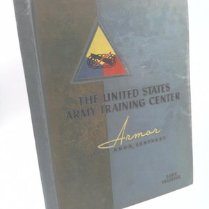 May include: A vintage book titled "The United States Army Training Center Armor Fort Knox, Kentucky Basic Training" with a yellow, blue, and red triangle emblem on the cover.